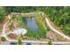 Aerial view of community pond surrounded by nature trails and greenery, offering a serene recreational area at 375 Banbury Xing, Alpharetta, GA 30009