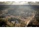 Wide aerial shot of a home surrounded by vast woodlands at 5211 Powers Ferry Rd, Sandy Springs, GA 30327