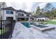 Beautiful backyard featuring an in-ground pool, hot tub, and patio with lounge chairs at 5211 Powers Ferry Rd, Sandy Springs, GA 30327