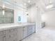 Bathroom features dual vanities with marble countertops, stylish fixtures, and a glass-enclosed shower at 5211 Powers Ferry Rd, Sandy Springs, GA 30327