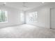 Bright bedroom with plush carpeting and large windows at 5211 Powers Ferry Rd, Sandy Springs, GA 30327