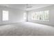 Large bedroom featuring neutral carpet, multiple windows with natural light at 5211 Powers Ferry Rd, Sandy Springs, GA 30327