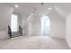 Bright bonus room features a ceiling fan, round window, and staircase with iron railing at 5211 Powers Ferry Rd, Sandy Springs, GA 30327