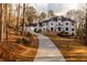 Elegant white home featuring a circular driveway and manicured lawn at 5211 Powers Ferry Rd, Sandy Springs, GA 30327