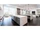 Open-concept kitchen features an island, gray cabinets, stainless steel appliances, and marble countertops at 5211 Powers Ferry Rd, Sandy Springs, GA 30327
