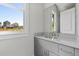 The bathroom features a gray vanity with brushed nickel hardware, grey walls, and a window at 7285 Cordery Rd, Cumming, GA 30040