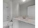 Bright bathroom features white cabinets, stone counters and modern fixtures and finishes at 7285 Cordery Rd, Cumming, GA 30040