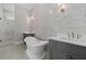 Elegant bathroom featuring a freestanding tub, gray vanity, marble countertop, and a glass enclosed shower at 7285 Cordery Rd, Cumming, GA 30040