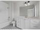 Stylish bathroom featuring white cabinets, quartz countertop and modern black and white patterned floors at 7285 Cordery Rd, Cumming, GA 30040