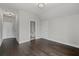 Bright room featuring hardwood floors and an ensuite bathroom with a toilet and shower at 7285 Cordery Rd, Cumming, GA 30040