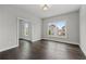 Sunlit bedroom with hardwood floors and a view of the neighboring homes at 7285 Cordery Rd, Cumming, GA 30040