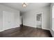 Bright bedroom with dark wood floors and ensuite bathroom access for a convenient layout at 7285 Cordery Rd, Cumming, GA 30040