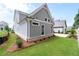 Well-manicured lawn, lush landscaping, and charming exterior of this beautiful home at 7285 Cordery Rd, Cumming, GA 30040