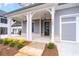 Charming front porch with stone pathway, traditional columns, and dark wood door creating an inviting entrance at 7285 Cordery Rd, Cumming, GA 30040