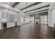 Spacious great room with hardwood floors, fireplace, built in bar, white trim, and lots of natural light at 7285 Cordery Rd, Cumming, GA 30040