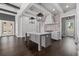 Contemporary kitchen with gray cabinets, hardwood floors, stainless steel appliances and a gray island with a white countertop at 7285 Cordery Rd, Cumming, GA 30040