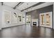Bright living room with a fireplace, dark wood flooring, and views of the backyard at 7285 Cordery Rd, Cumming, GA 30040
