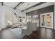 Bright living room with hardwood floors, beamed ceiling, modern furniture, fireplace, and French doors to patio at 7285 Cordery Rd, Cumming, GA 30040