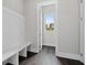 Mudroom with bench seating, open door and beautiful view at 7285 Cordery Rd, Cumming, GA 30040