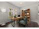 Bright home office with wooden desk, bookshelf, dark floors and large window with neighborhood view at 7285 Cordery Rd, Cumming, GA 30040
