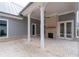 Covered brick patio featuring a stone fireplace, perfect for outdoor entertaining at 7285 Cordery Rd, Cumming, GA 30040