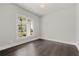 Empty room showcasing the hardwood floors, and natural light at 7285 Cordery Rd, Cumming, GA 30040