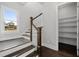 The staircase boasts dark wood treads, white risers and railings, and neighborhood view at 7285 Cordery Rd, Cumming, GA 30040