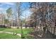 View of backyard featuring a lush lawn, mature trees and a wooden privacy fence at 2283 Stratmor Dr, Tucker, GA 30087