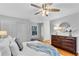 Elegant main bedroom with hardwood floors, ceiling fan, and a decorative dresser at 2283 Stratmor Dr, Tucker, GA 30087