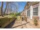 Landscaped backyard with tiered retaining wall, steps to deck, and views of the rear elevation at 2647 Brickell Sq, Atlanta, GA 30341