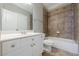 Well-lit bathroom featuring a white vanity and bathtub with decorative tile surround at 2647 Brickell Sq, Atlanta, GA 30341