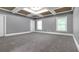 Bright bedroom with tray ceiling, recessed lighting, and plush neutral carpeting at 2647 Brickell Sq, Atlanta, GA 30341