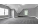 Spacious bonus room with gray walls, plush carpeting, and natural light from two windows at 2647 Brickell Sq, Atlanta, GA 30341