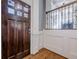 Elegant foyer featuring hardwood floors, dark wood door and staircase and white trim at 2647 Brickell Sq, Atlanta, GA 30341