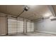 Two-car garage featuring a concrete floor and two white paneled doors at 2647 Brickell Sq, Atlanta, GA 30341