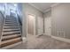 Carpeted hallway with staircase, leading to doorways and a view of upper levels at 2647 Brickell Sq, Atlanta, GA 30341