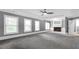 Spacious living room with plush carpeting, tray ceilings, fireplace and many windows at 2647 Brickell Sq, Atlanta, GA 30341