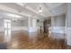 Open-concept living area with hardwood floors, coffered ceilings, and access to the staircase at 2647 Brickell Sq, Atlanta, GA 30341