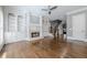 Open living room with hardwood floors, fireplace, and built-in shelving providing ample storage space at 2647 Brickell Sq, Atlanta, GA 30341