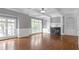 Bright living room with hardwood floors, a fireplace, built-in shelving, and large windows at 2647 Brickell Sq, Atlanta, GA 30341