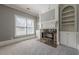 Cozy living room with a marble fireplace, built-in bookshelves, and plush carpet at 2647 Brickell Sq, Atlanta, GA 30341