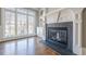 Cozy living room featuring a fireplace with stone hearth, large windows, and built-in shelves at 2647 Brickell Sq, Atlanta, GA 30341
