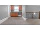 Carpeted loft area with a built-in wet bar, cabinets and decorative wrought iron railing at 2647 Brickell Sq, Atlanta, GA 30341