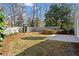 View of backyard shows the fence, grass, bushes and trees at 325 Whitley Park Dr, Atlanta, GA 30350