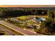 Aerial view of a community with clubhouse, pool, parking, walking trails and surrounded by lush green trees at 41 Okeechobee Way, Braselton, GA 30548