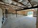 Unfinished basement with exposed beams, concrete floors, and a sliding glass door at 41 Okeechobee Way, Braselton, GA 30548