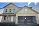 Two-story home featuring a large garage, inviting front porch, and craftsman-style details at 41 Okeechobee Way, Braselton, GA 30548