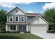 Charming two-story home with light blue siding, white trim, a two car garage, and a well-manicured lawn at 41 Okeechobee Way, Braselton, GA 30548