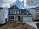 Charming two-story home with a covered front porch and attached two-car garage at 41 Okeechobee Way, Braselton, GA 30548