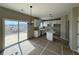 Bright kitchen with white cabinets, an island, stainless steel sink and sliding glass doors to the deck at 41 Okeechobee Way, Braselton, GA 30548
